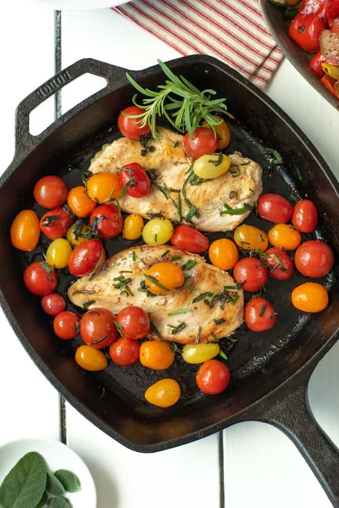 An overhead view of Herbed Brown Butter Chicken with Tomatoes in a pan