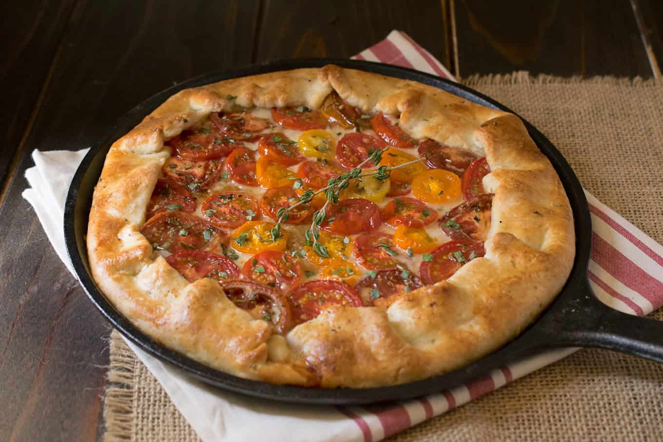 Colorful tomato slices inside a pastry crust