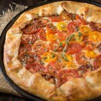 Herbed tomato galette using red and yellow tomatoes garnished with fresh herbs