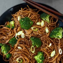 Hoisin broccoli and noodles with chopped scallions in a bowl