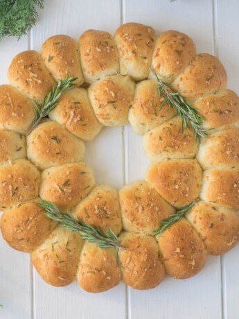 An edible wreath made from bread rolls viewed from overhead