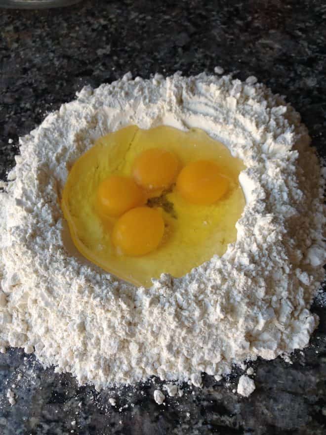 A mound of flour with eggs in the center