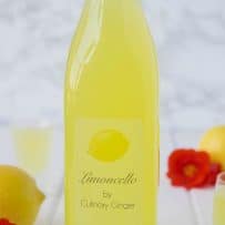 A large bottle filled with limoncello with a custom label that reads Limoncello by Culinary Ginger