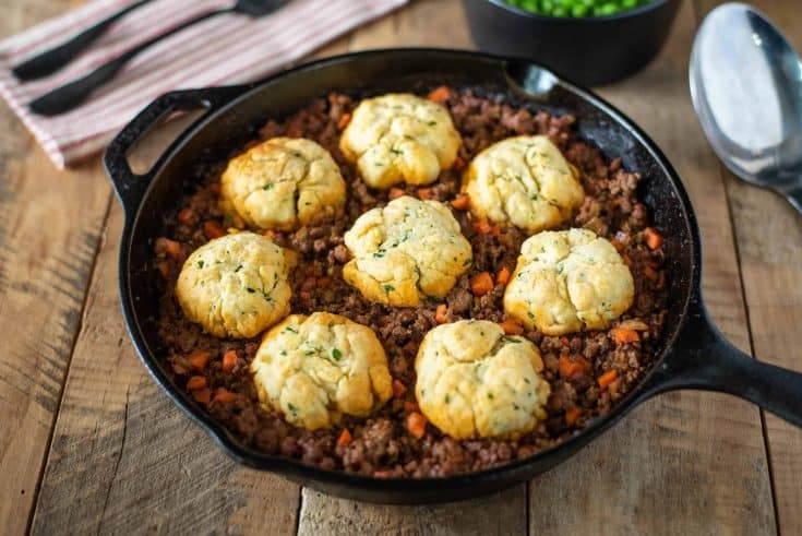 Minced beef in a pan topped with dumplings