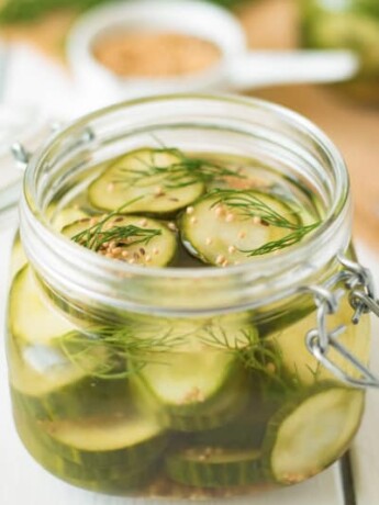 A poptop lid jar filled with dill pickle chips