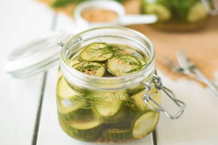 A poptop lid jar filled with dill pickle chips