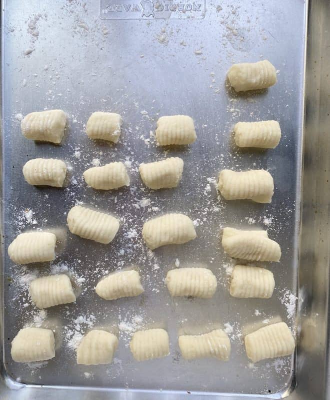 Rolls of gnocchi on a lightly floured sheet pan