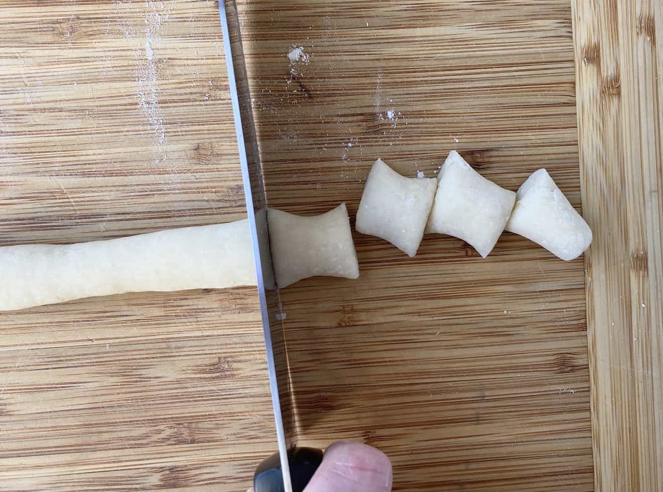 Using a knife to cut gnocchi