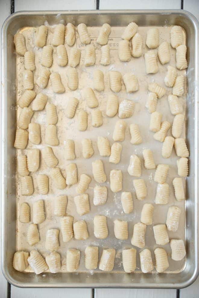 Newly rolled gnocchi on a board to dry
