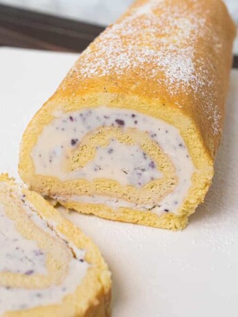 Blueberry and strawberry swirled ice cream rolled in a yellow sponge cake