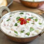 Chopped tomatoes and cucumber in a yogurt raita