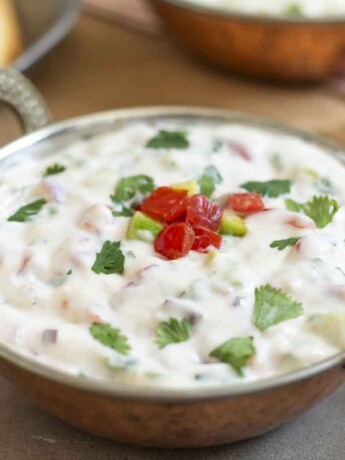 Chopped tomatoes and cucumber in a yogurt raita