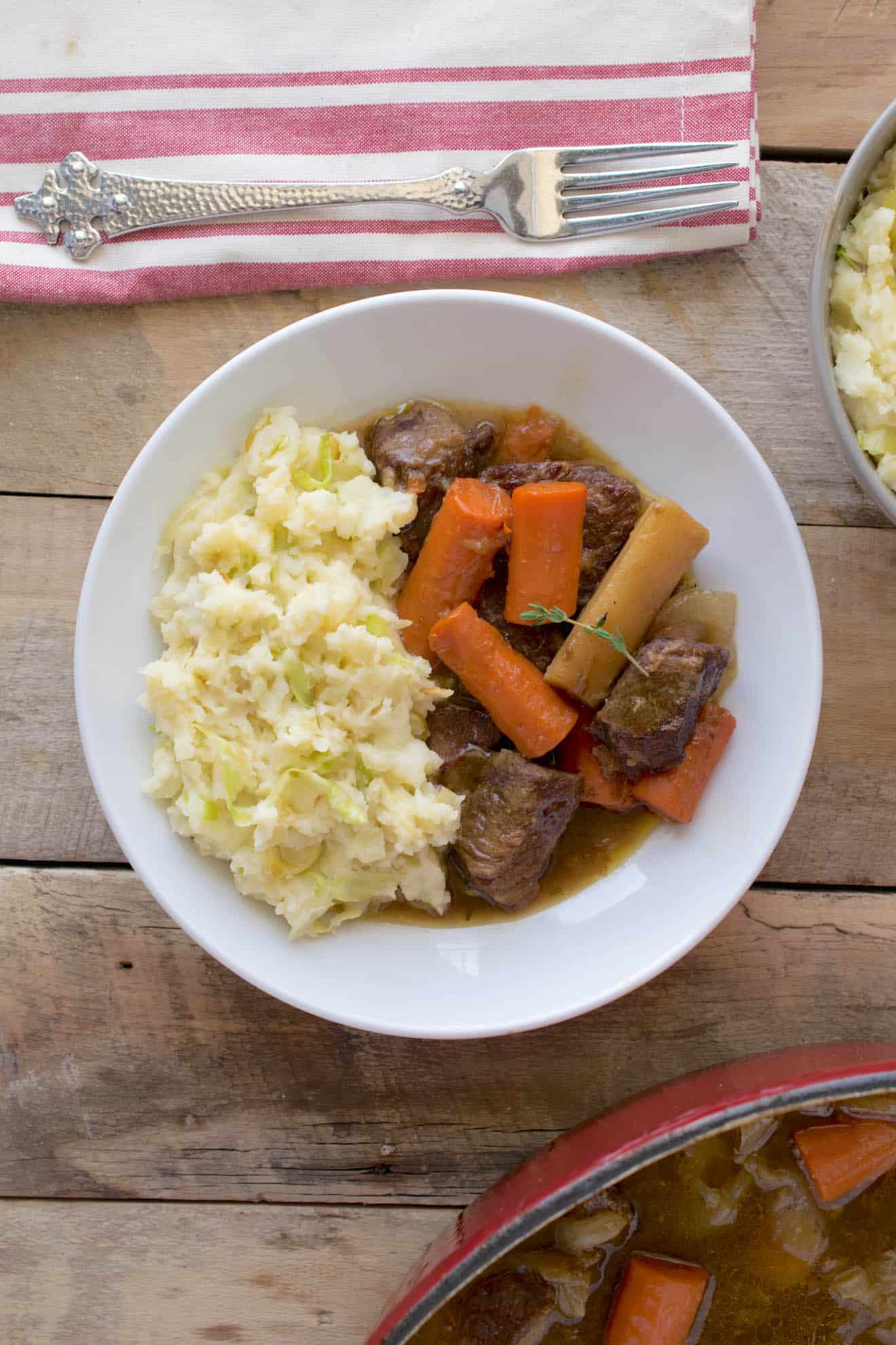 Irish beef and Guinness stew on a plate with mashed potatoes