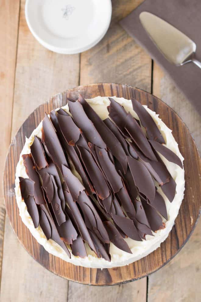Homemade chocolate shards lay on top of a chocolate cake