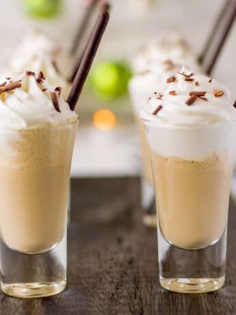 A side view of 2 shot glasses filled with Irish coffee milkshake