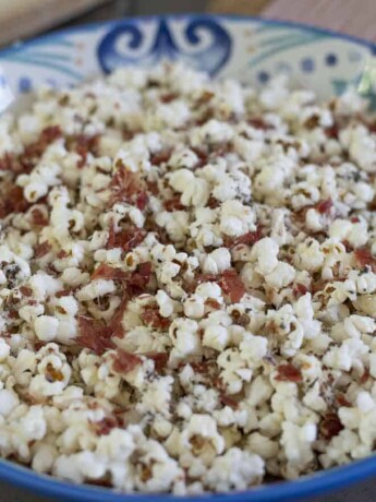 An Italian style decorative bowl filled with popcorn