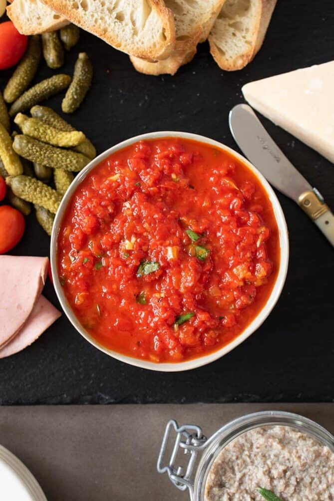 Vibrant red pepper relish in a white bowl