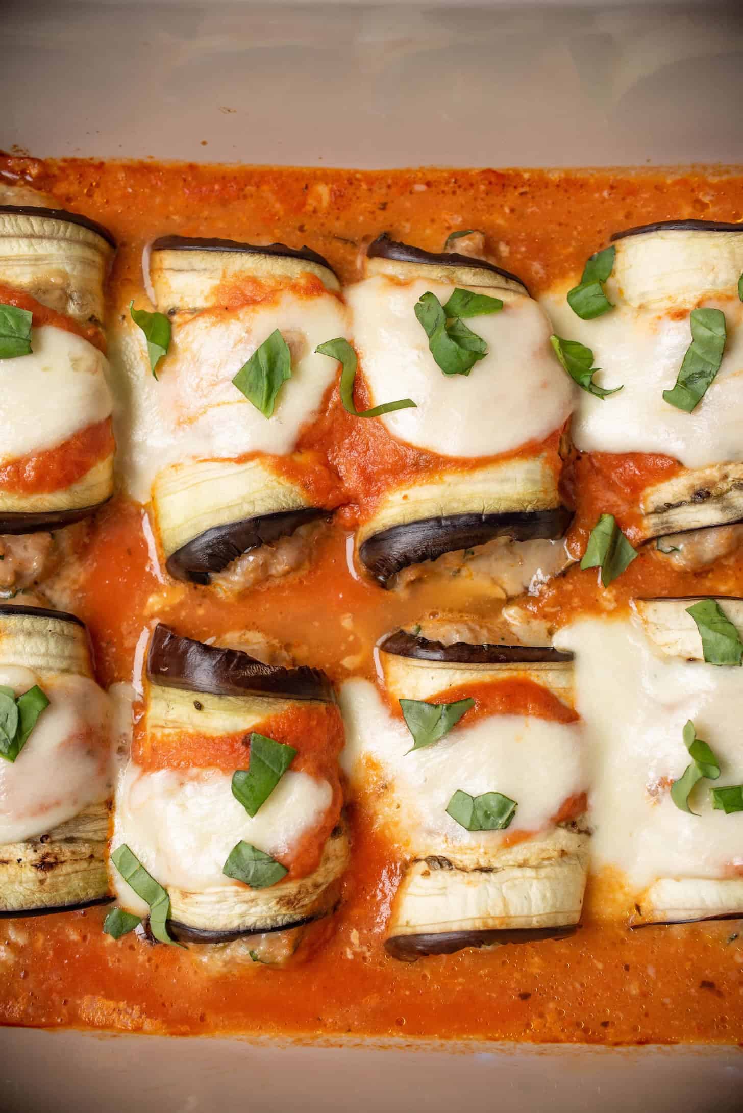 Rolls of eggplant filled with Italian sausage in tomato sauce