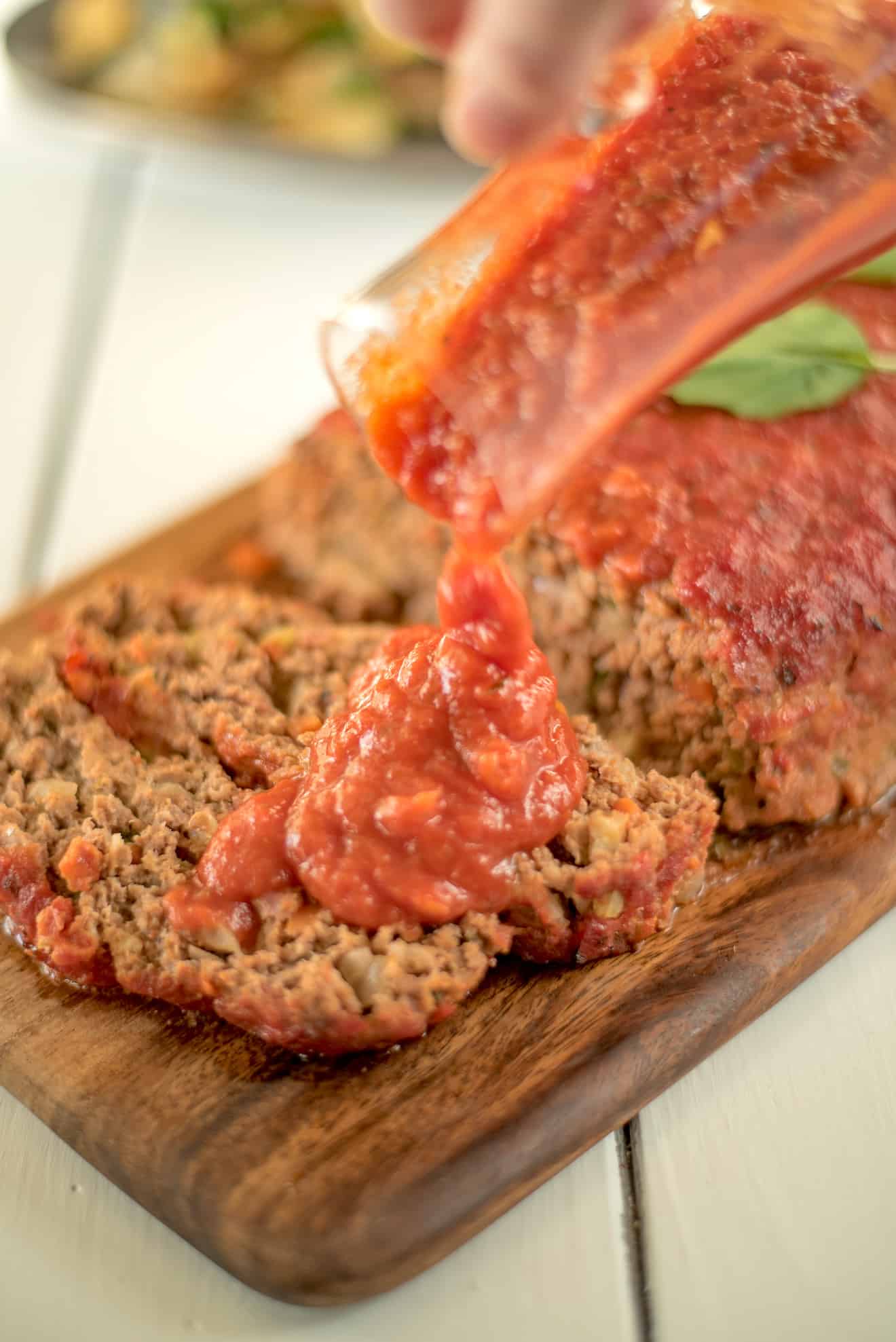 Slices of meatloaf topped with tomato marinara sauce