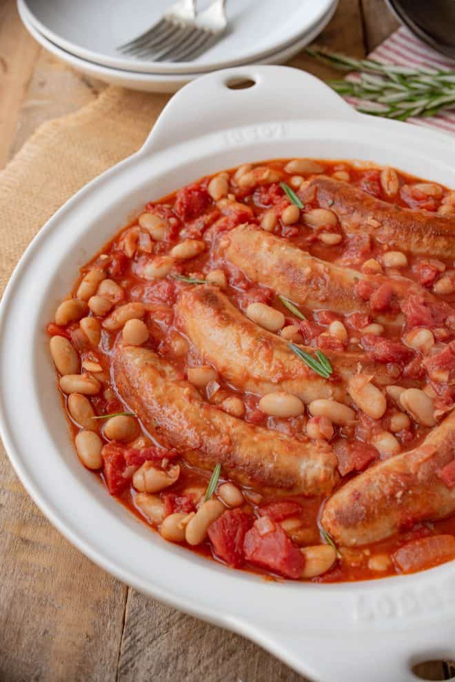 A closeup of the sausages nestled in the beans and tomato sauce