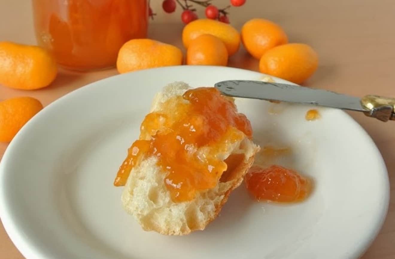 A crusty piece of bread topped with kumquat marmalade