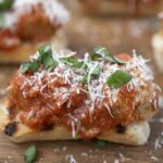 Meatballs and sauce on top of crostini