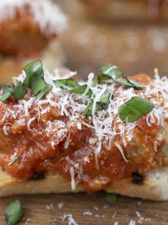 Meatballs and sauce on top of crostini