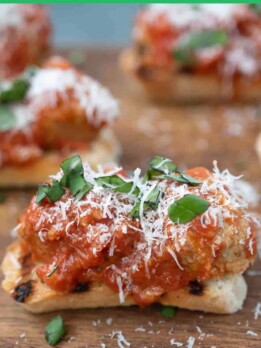 Grilled crispy bread topped with meatballs and sauce