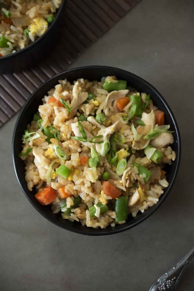 An overhead view of a bowl of vegetable fried rice