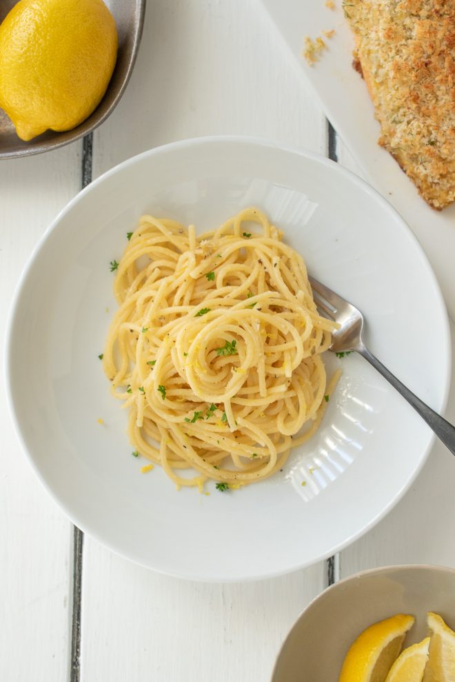 A bowl of lemon pepper spaghetti from above with a fork
