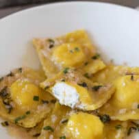 Square ravioli on a plate with butter and mint sauce