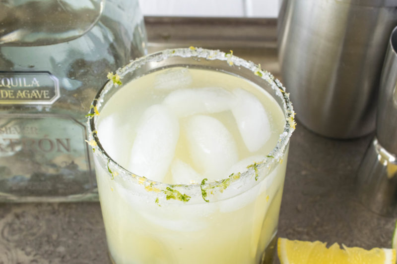 A closeup showing a salt, lemon and lime rimmed glass