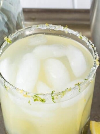 A closeup showing a salt, lemon and lime rimmed glass