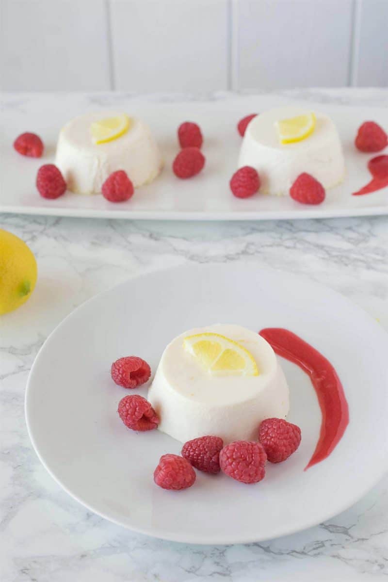 Lemon panna cotta with raspberry sauce. Creamy and sweet, this is an easy dessert that can be made ahead, refrigerated and served when you're ready for dessert.
