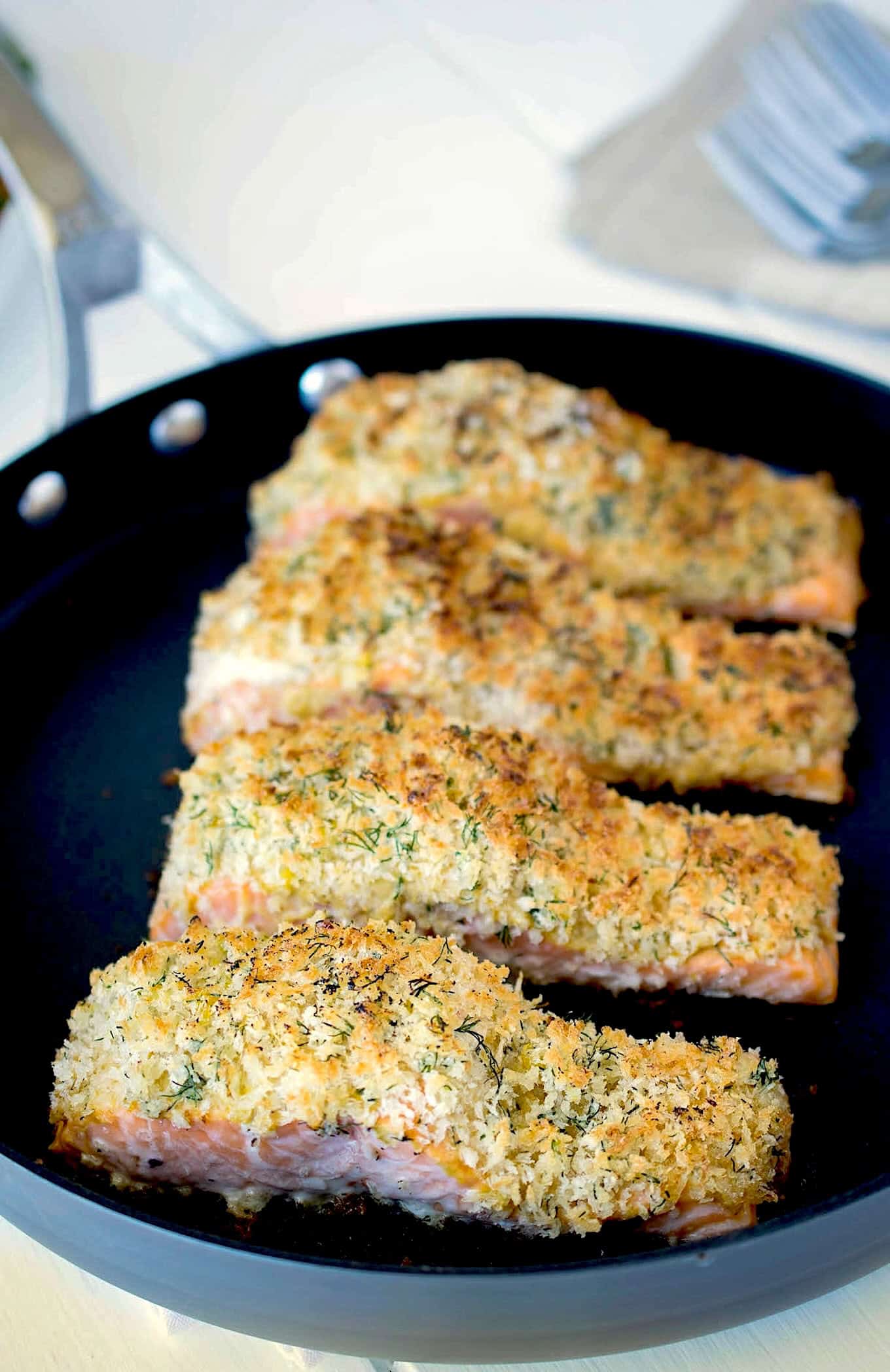 4 salmon fillets in a pan