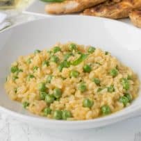 A closeup of risotto with fresh green peas