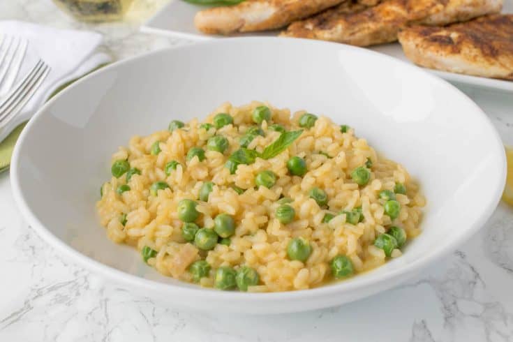 A closeup of risotto with fresh green peas
