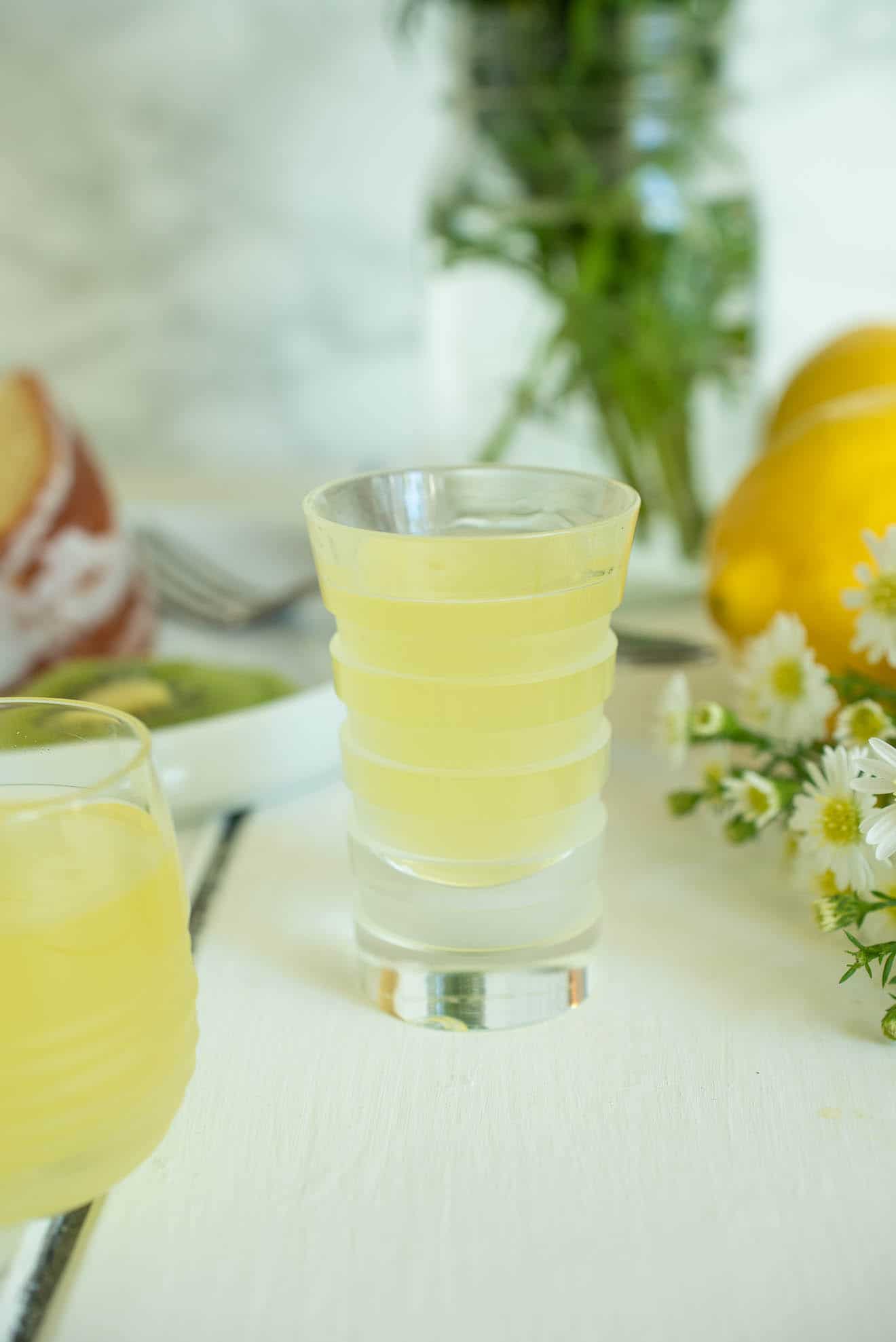 2 glasses of limoncello with daisies and lemons