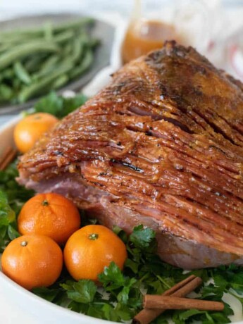 Spiral sliced ham on a serving platter with vegetables