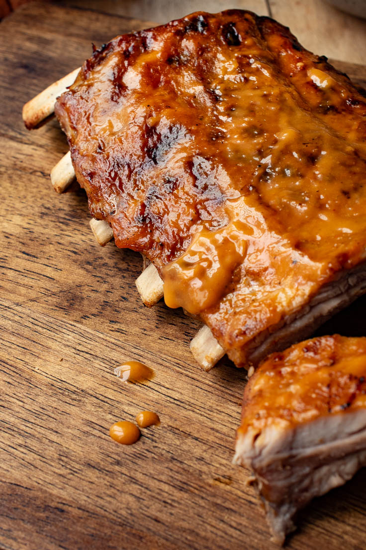 Grilled ribs dripping with mango barbecue sauce