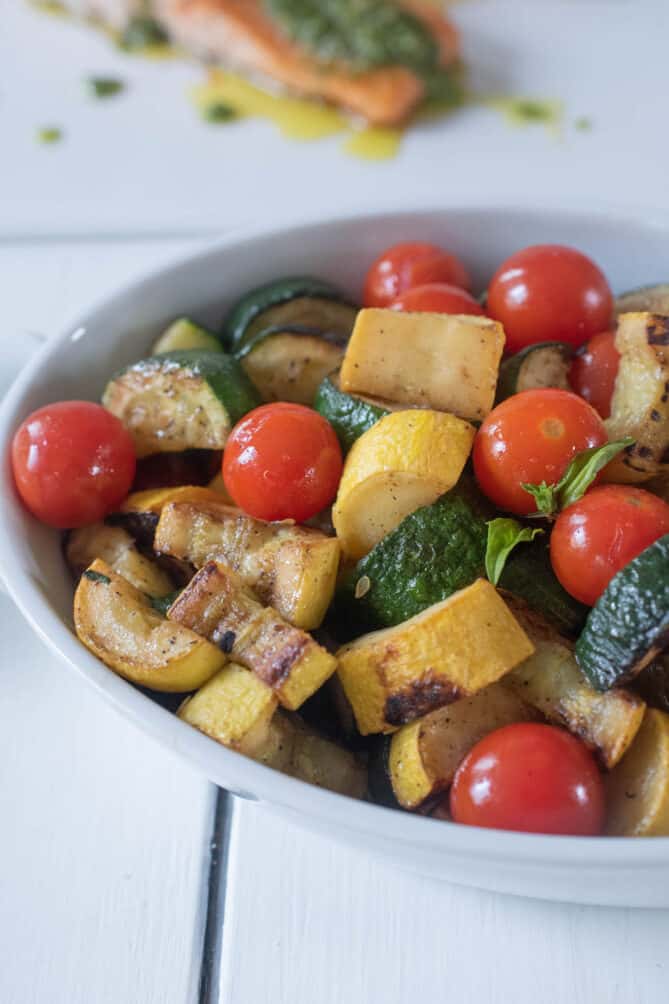 A bowl of sautéed zucchini and cherry tomatoes