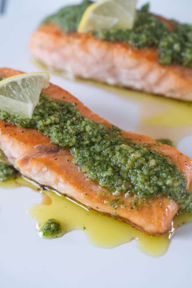 A closeup showing the vibrant green pesto on the salmon