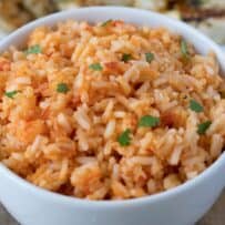 Red Mexican rice garnished with chopped cilantro