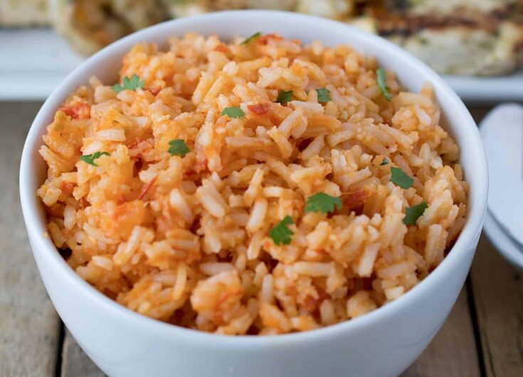 Red Mexican rice garnished with chopped cilantro