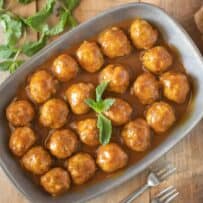 A platter of meatballs in curry sauce viewed from overhead