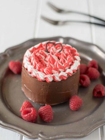 A mini chocolate cake with red, white and chocolate frosting