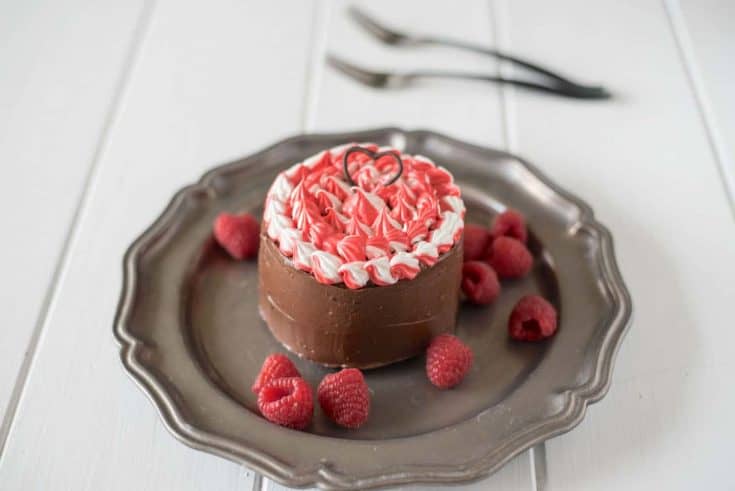 A mini chocolate cake with red, white and chocolate frosting