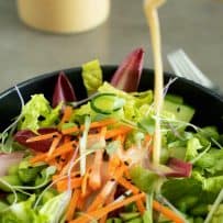 Miso dressing drizzled onto vegetables and salad