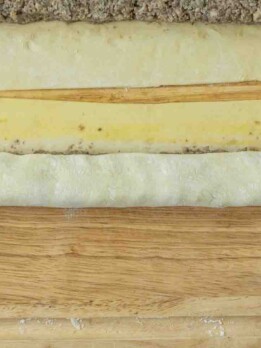 Rolling puff pastry to make sausage rolls