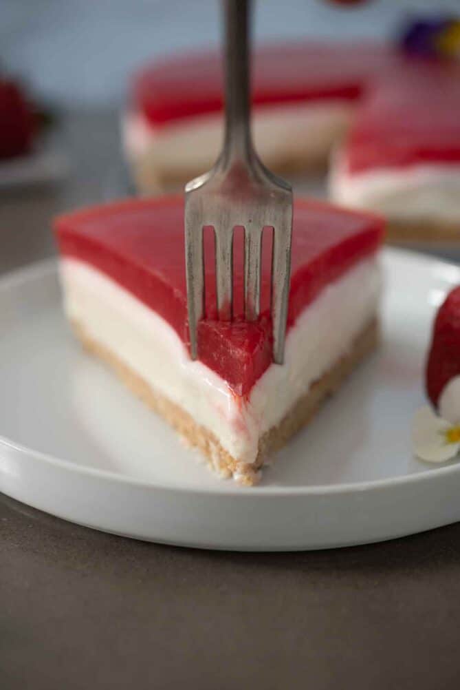 Using a fork to get a bite of cheesecake